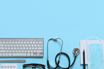 Composition with modern stethoscope and computer keyboard on color background