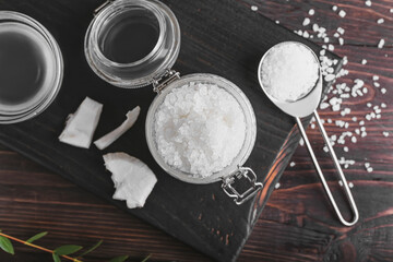 Fototapeta premium Composition with coconut body scrub and ingredients on dark wooden background