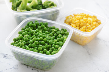 Plastic containers with vegetables on light background, closeup