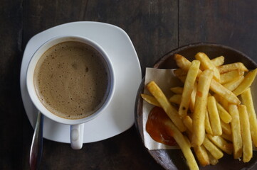 cappuccino served with fried fries for coffee break at the office