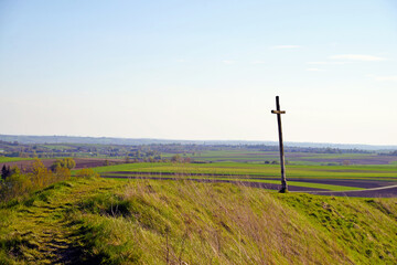 Fototapeta na wymiar Rural landscape of meadows and fields and cross