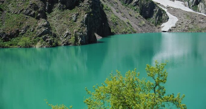 Mountain Lake of green and blue color Urungach. Located in Uzbekistan, Central Asia. 5 out of 10