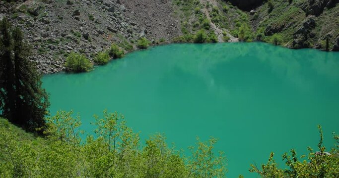 Mountain Lake of green and blue color Urungach. Some pine trees. Located in Uzbekistan, Central Asia. 13 out of 20  Tyanshan mountains