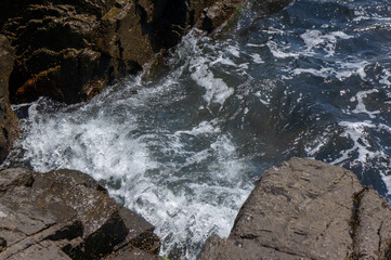 Sea surf day landscape. Sea waves with white foam breaks on stones. Sozopol. Bulgaria