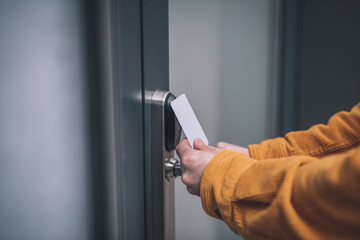Close up of mans hand opening the door with an access card