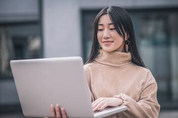 An asian young woman with a laptop
