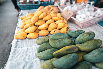 Ripe mangoes on the table in the market