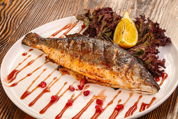 Grilled sea bass served lemon