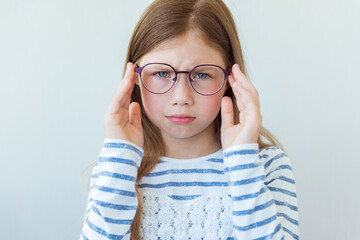 Health care, eyeball check, clear vision concept. Close up portrait of upset schoolgirl in new...