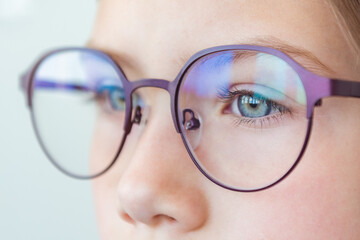 Health care, eyeball check, clear vision concept. Close up portrait of pensive schoolgirl in new...