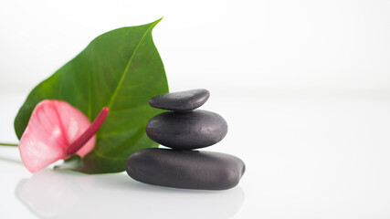 Obraz na płótnie Canvas Zen concept balancing dark stones on mirrored background