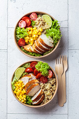 Chicken and quinoa salad with corn and tomatoes in craft eco bowl. Zero waste, to go food,...