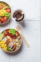 Chicken and quinoa salad with corn and tomatoes in craft eco bowl. Zero waste, to go food,...