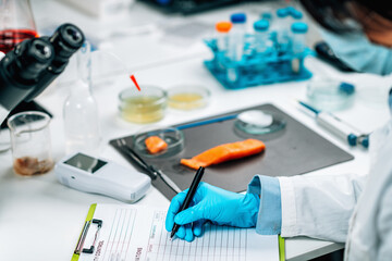 Food Safety and Quality Management. Inspector Filling Out Quality Control Form in a Laboratory
