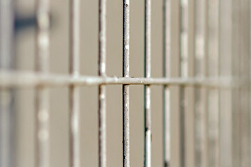 Gray metal vertical stripes fence. Abstract gray background. Close-up.