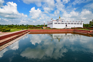 Obraz premium Reflection of a Buddhist temple on water at Lumbini, Nepal, the birth place of Buddha