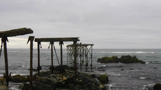 Ruins of the historic, 120-year-old pier in Llico, Vichuquen, Chile, scenic shot