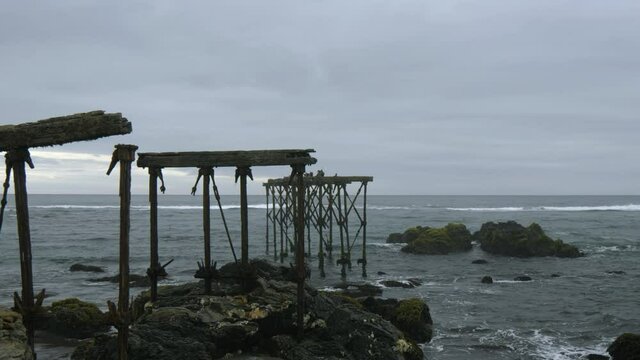 Ruins of the historic, 120-year-old pier in Llico, Vichuquen, Chile, wide shot