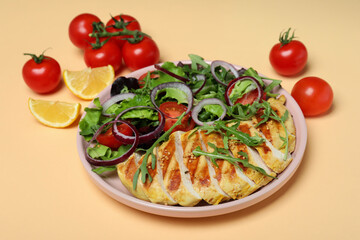 Salad with grilled chicken and ingredients on beige background