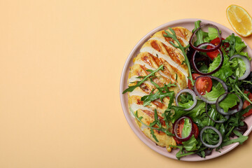 Salad with grilled chicken and ingredients on beige background