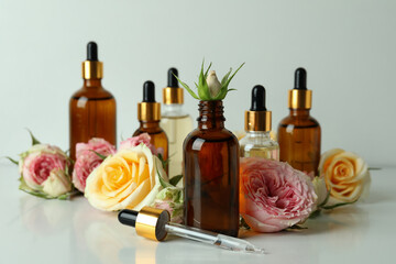Skin care concept with essential rose oil on white background
