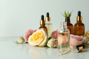 Obraz na płótnie Canvas Skin care concept with essential rose oil on white background