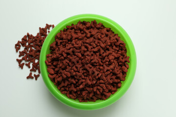 Pet bowl with feed on white background