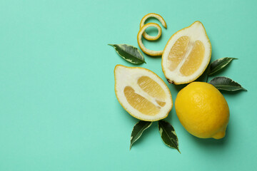 Ripe lemons on mint background, space for text