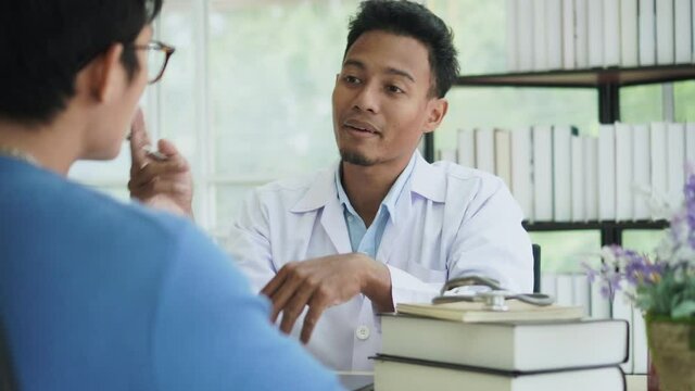 slow motion scene hispanic professional doctor man talk and advise male patient about health  in office room for lifestyle concept
