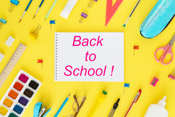 Back to school. Education concept. Everything for school and office. School supplies. Pens, pencils, notebook, glasses and everything for study on a yellow background. Flatly. From above.