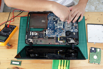 Close up of technician engineer trying to repairing broken laptop. Computer repairs and upgrade