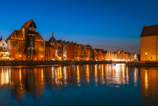 Gdansk night city riverside view. View on famous crane and facades of old medieval houses