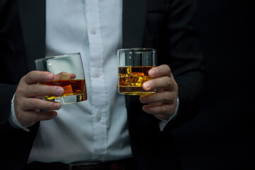 Closeup businessmen holding a glass of whiskey
