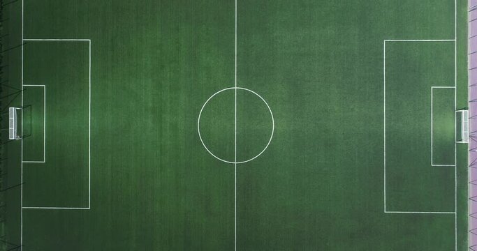 Aerial view of green football, soccer pitch. Top down view on a green, empty soccer field