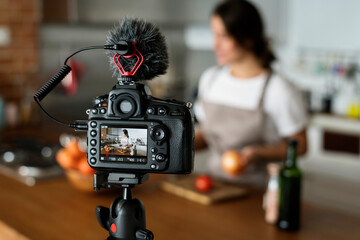 Female vlogger recording cooking related broadcast at home - Powered by Adobe