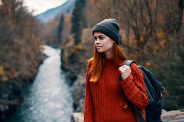 Tourist with a backpack in the forest on nature mountains river travel