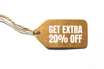 GET EXTRA 20 OFF percent text on a brown tag on a white paper background