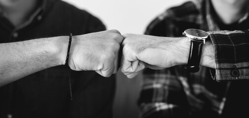 Closeup of men fist bumping