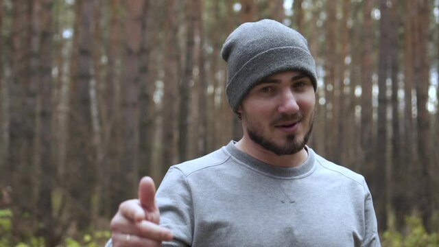 Portrait of a Young Man in the Autumn Forest, Who Sings Rap, Gests Hands and Looks at the Camera