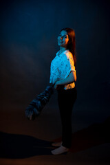 Girl in a shirt with pipidustre illuminated by complementary light