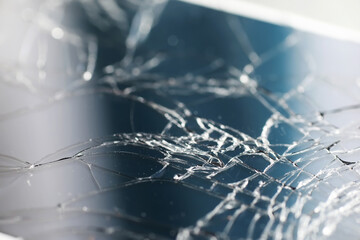 Crack on the glass. Broken screen. Broken phone. Cracked glass background. White cracks in the glass.