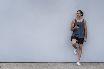 Athlete man with smartphone on a training break