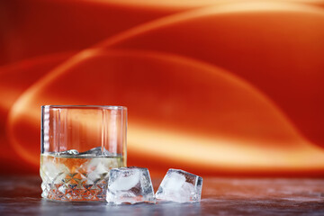 A glass of hard alcohol with ice on a bar counter. Whiskey with soda in a glass. Advertising...