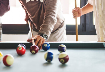 Friends playing pool game together - Powered by Adobe