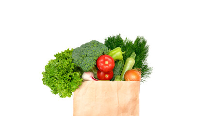Various food, vegetables, fruits in a paper bag on a white isolated background. Vegetarian food delivery. Concept for grocery shopping, home delivery of groceries, top view with copy space. Flat lay