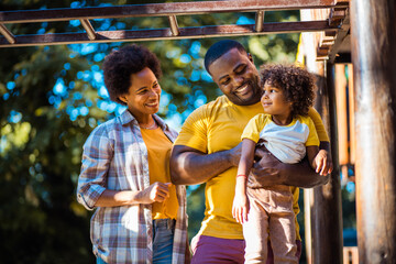 Obraz na płótnie Canvas African American family having fun outdoors.