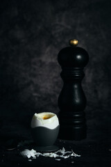 Obraz na płótnie Canvas soft-boiled egg on a stand on a dark background