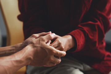 Man holding a woman's hand for warm, as psychological counseling concept of support, understanding...