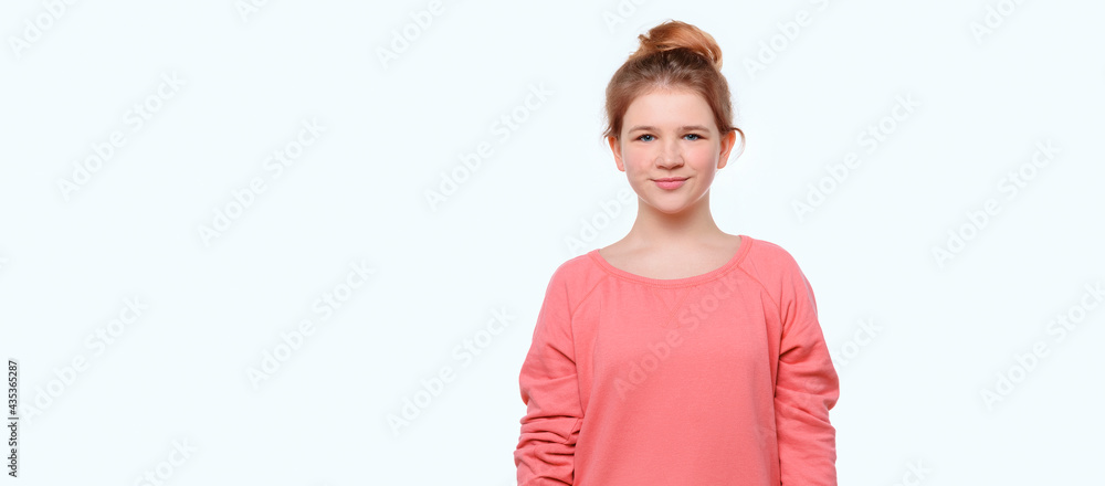 Wall mural portrait of happy little girl in pink casual sweatshirt. place for your text