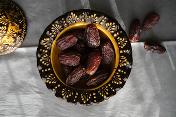 Delicious dates in an inlaid ceramic bowl